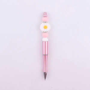 Detail of pink beaded pen with white daisy flower charm and sparkling spacer rings