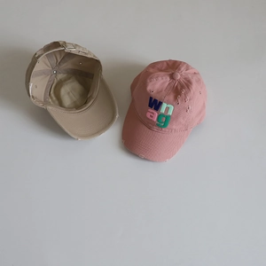 Detailed view of kids cotton baseball caps with vintage distressed edges and embroidery