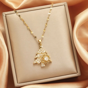 Collana albero di Natale oro rotante con fiocco di neve e zirconi su raso