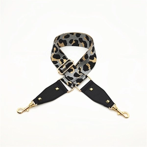 Adjustable leopard print wide shoulder strap with leather trim and gold metal buckles