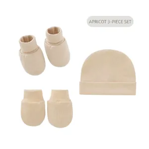 Detail view of the apricot newborn cotton hat, mittens, and socks 3-piece set