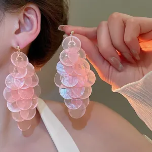 Pink shell tiered long drop earrings with gold studs for a stylish beach vacation look