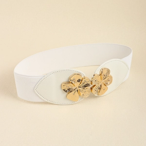 Detailed shot of white elastic waist belt with gold 3D flower buckle on PU leather