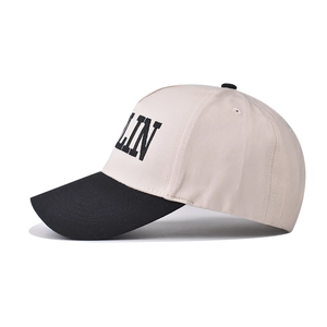 Detail of cotton baseball cap featuring black LIN embroidery and contrasting brim design