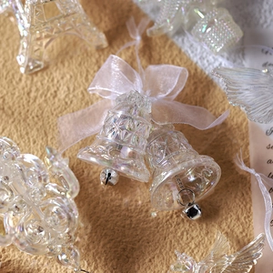 Colorful clear acrylic Christmas bell ornaments with ribbon bows and iridescent finish