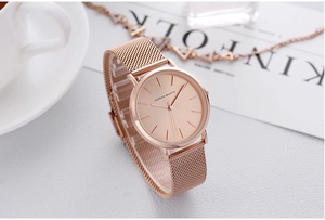 Detailed close-up of rose gold mesh watch band and elegant minimalist dial display