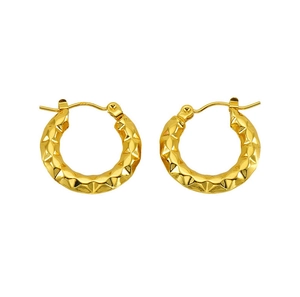 Detail of 18K gold hoop earrings featuring geometric diamond-cut textures and latch closure
