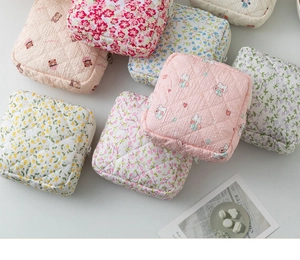 Detailed view of quilted floral pouches with zippers for organizing small items