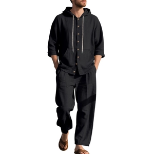Detail of black linen men's hooded shirt with wooden buttons and matching beach trousers