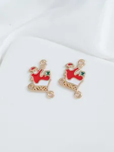 Detail of Christmas Santa sleigh enamel charms in gold metal for DIY jewelry making