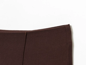 Detailed close-up of brown twill fabric with vertical side seam on lapel suit set