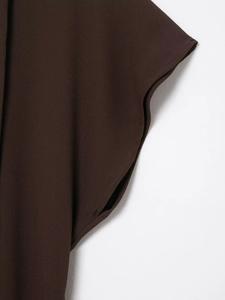 Detail shot of the sleeve cuff on a deep brown midi dress showing fine stitching