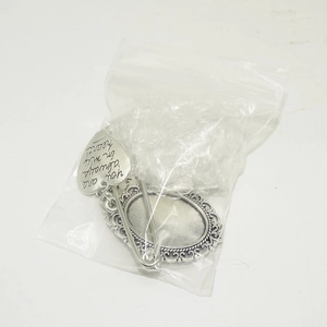 Detail view of heart-shaped silver pin pendant with 'You are always in my heart' engraving