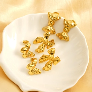 Three pairs of 18K gold-plated stainless steel bow earrings with a liquid lava design