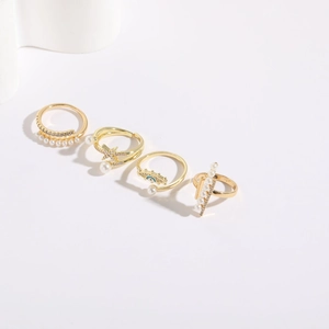 Detail view of 14K gold plated rings set with freshwater pearls and zircon accents