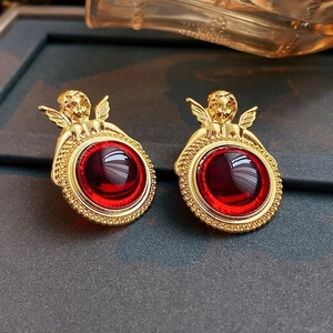 Vintage angel wings earrings with red gemstone center in polished golden finish