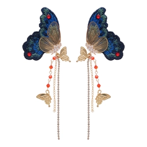Boucles d'oreilles papillon avec broderie bleue, cristaux et longs glands dorés chic
