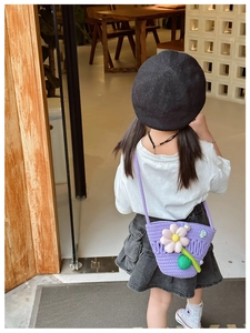 Detail of purple knitted kids crossbody bag featuring 3D flower decoration and leaf accent