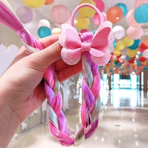 Détail de l'élastique papillon rose pailleté avec extensions tressées en dégradé coloré