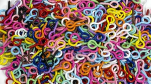 Close-up of colorful painted metal eye screws for DIY crafts in various vibrant shades