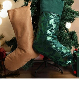 Detail of dark green velvet Christmas stocking with embossed triangles and hanging loop
