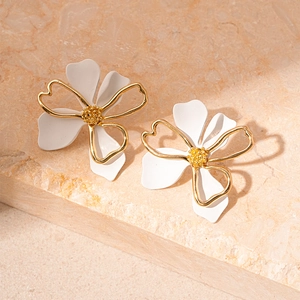 Detailed close-up of double-layer white flower petal earrings with golden metallic edges