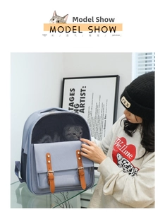 Detail of light blue pet backpack featuring a mesh window and buckle pocket