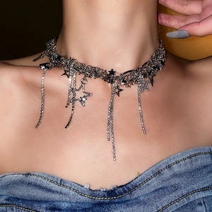 Detail view of silver star necklace with sparkling rhinestone tassel chains on neck
