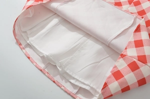 Detail view of the inner white lining and sewing on the red gingham halter dress