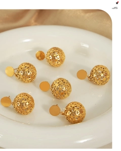 Detailed macro view of 18K gold-plated hollow geometric ball earrings with intricate cutout