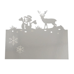 Macro shot of silver laser-cut place card featuring snowman, reindeer, and snowflake details