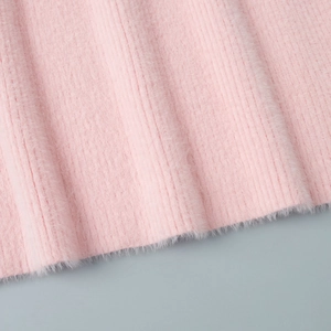 Close-up of pink plush ribbed knit fabric showing soft faux mink fur texture detail