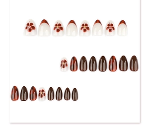 Detail view of 24pcs almond nails with amber texture, floral art and glossy finish