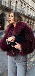Close-up of wine red faux fur coat texture with elegant notch lapel and long sleeves