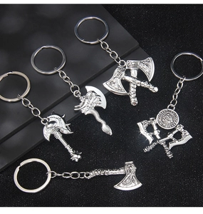 Detailed macro view of five distinct Viking battle axe metal keychains with silver finish