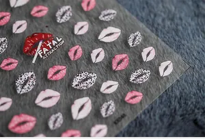 Macro shot of 5D ultra-thin nail stickers featuring various red lips and leopard patterns