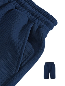 Close-up of deep blue waffle knit texture and drawstring elastic waistband on men's shorts