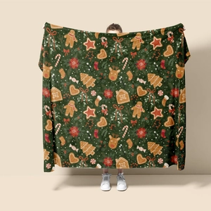 Detail of Christmas flannel blanket with gingerbread man and reindeer festive patterns