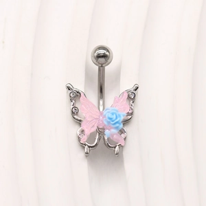 Macro shot of silver butterfly belly ring with pink resin wings and a blue rose