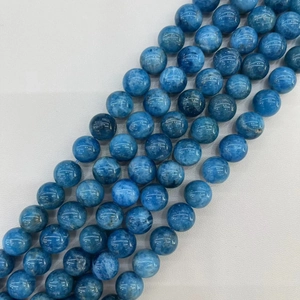 Close-up of lapis lazuli loose round beads showing natural blue textures and glossy finish