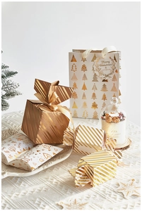 Detail showing elegant gold-foiled Christmas gift boxes and matching paper bags set