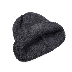 Detailed view of dark grey winter beanie featuring thick ribbed knit and folded cuff