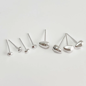 Macro shot of 925 sterling silver irregular stone-shaped stud earrings set in silver