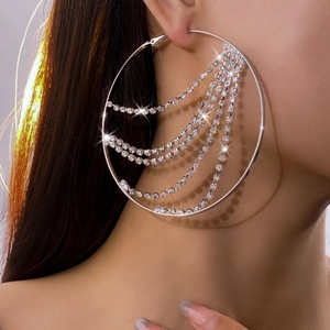 Close-up of sparkling rhinestone fringe hoop earrings worn for a luxury fashion look