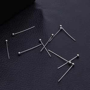 Polished silver stainless steel ball head pins for DIY jewelry making on leather surface