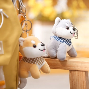 Cute Shiba Inu and Husky plush keychains with scarves on a yellow backpack