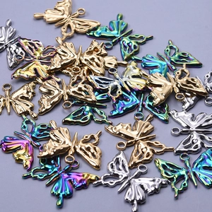 Detailed macro view of 304 stainless steel butterfly charms in gold, silver, and iridescent