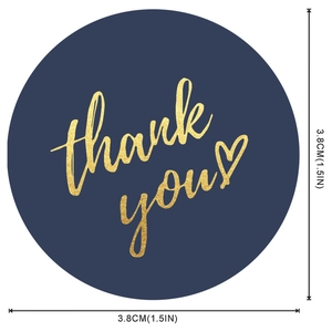 Detail of 3.8cm round gold foil 'thank you' sticker with heart on navy background