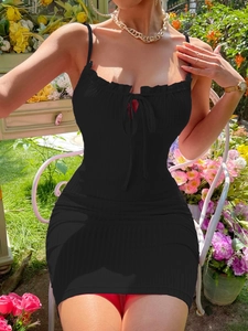 Detail of black slim fit mini dress featuring drawstring bust and ribbed knit texture