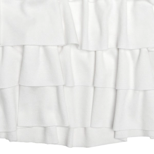 Detailed view of layered white ruffled hem on high-quality ribbed knit dress fabric